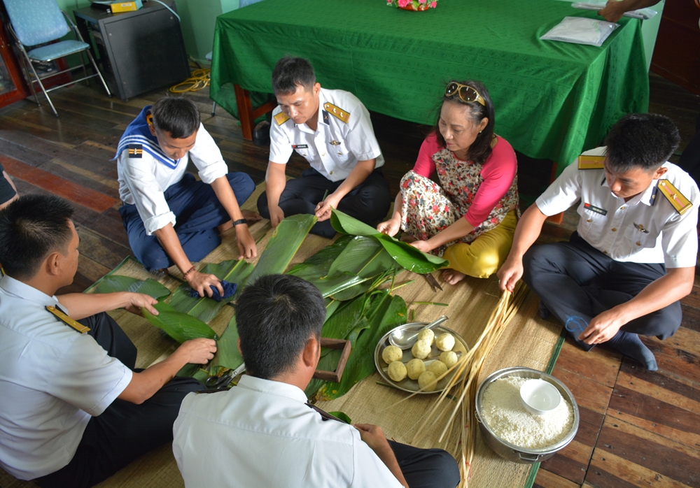 Các thành viên của Đoàn công tác và cán bộ, chiến sĩ Nhà giàn DK1/10 cùng gói bánh chưng.