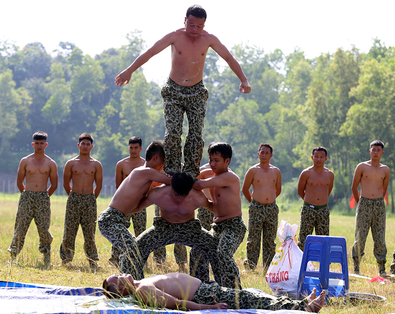 Nằm trên thủy tinh “vận công” chịu lực của đồng đội nhảy từ trên cao xuống.