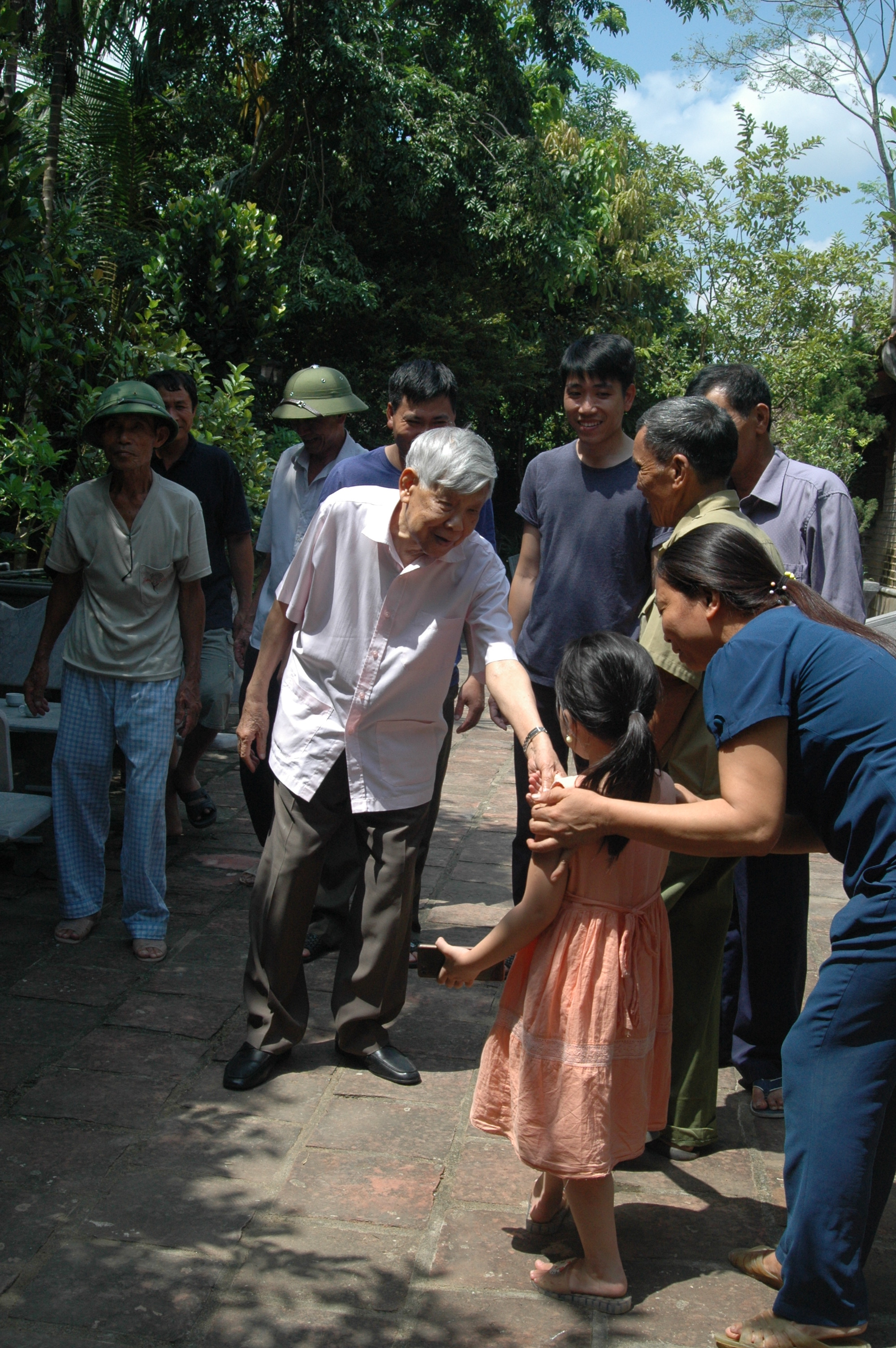 Nguyên Tổng Bí thư Lê Khả Phiêu trò chuyện thân mật với bà con hàng xóm và rất quan tâm đến trẻ nhỏ.