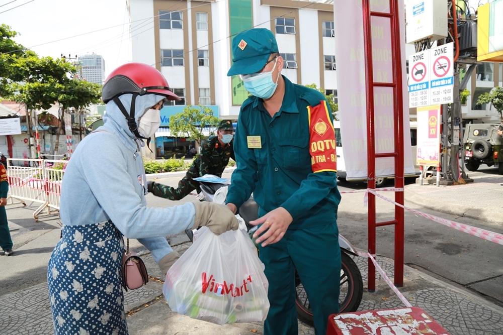 Lực lượng dân quân giúp người dân tiếp tế lương thực, thực phẩm cho các hộ dân trong khu vực bị phong tỏa.