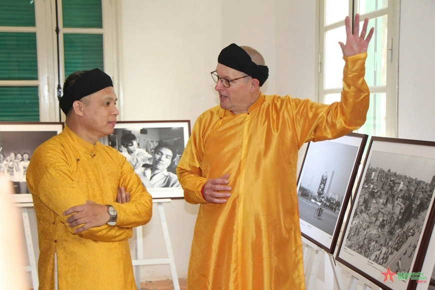 Hai nhiếp ảnh gia Andy Soloman và Lê Bích trò chuyện về các bức ảnh tại triển lãm “Hà Nội - một thời để nhớ” (tháng 10-2024). Ảnh: qdnd.vn