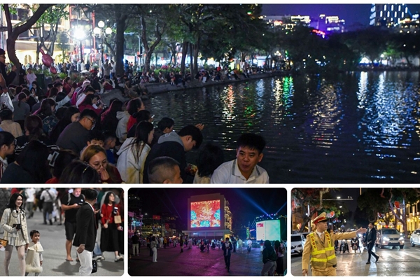 Người dân đổ về khu vực Hồ Hoàn Kiếm chuẩn bị xem pháo hoa đón chào năm mới