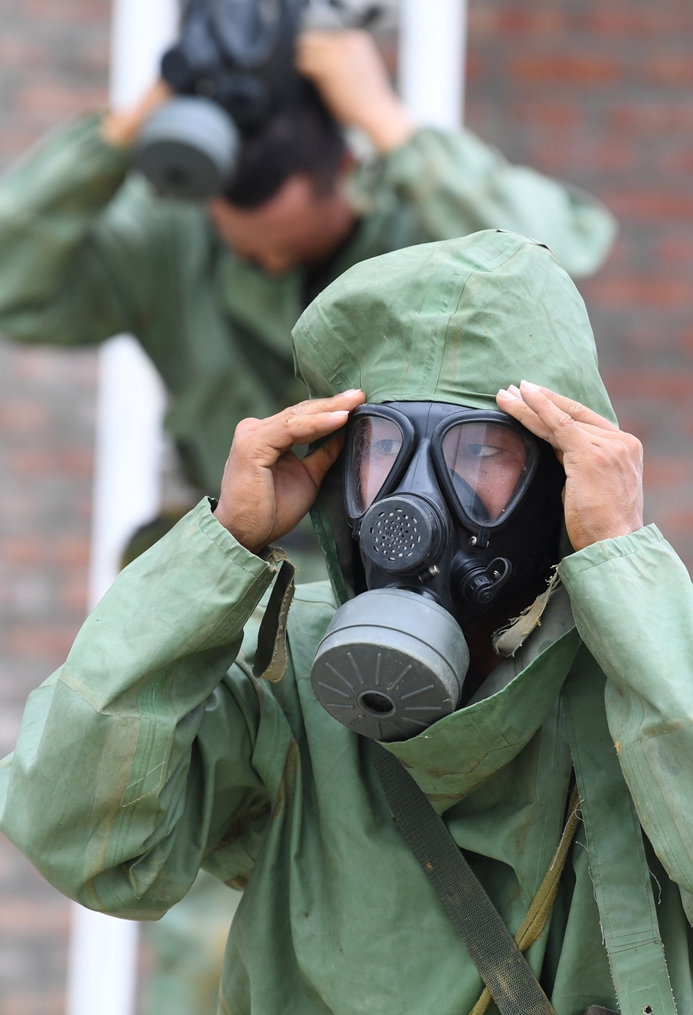 Mang mặc đồ phòng hóa cá nhân.