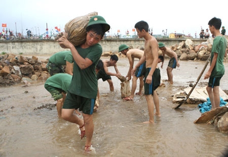 Cán bộ, chiến sĩ Trung đoàn 50 triển khai bờ bao, chống nước biển xâm nhập vào đơn vị và khu dân cư.