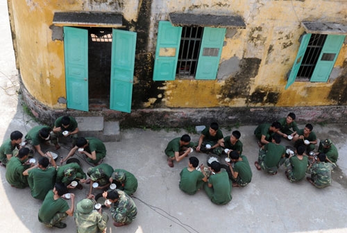 Sau bữa cơm dã chiến, cán bộ chiến sĩ Trung đoàn 8 lại nhào mình xuống ruộng gặt lúa giúp dân.