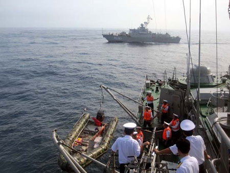 Tàu HQ 261 thả xuồng mang theo mục tiêu đã vớt được để trao lại cho phía Trung Quốc.