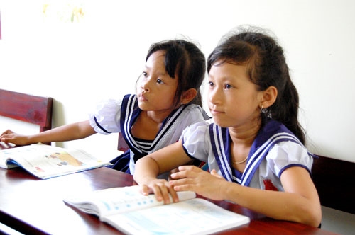 Chăm chú nghe cô giáo giảng bài trong lớp